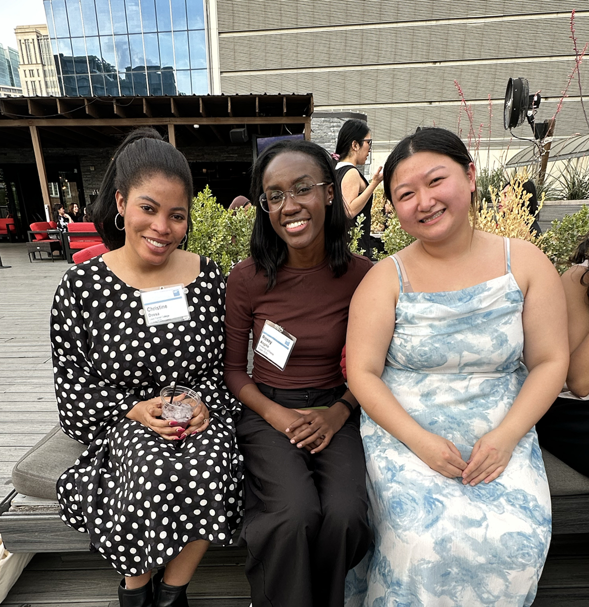three women smiling at a conference