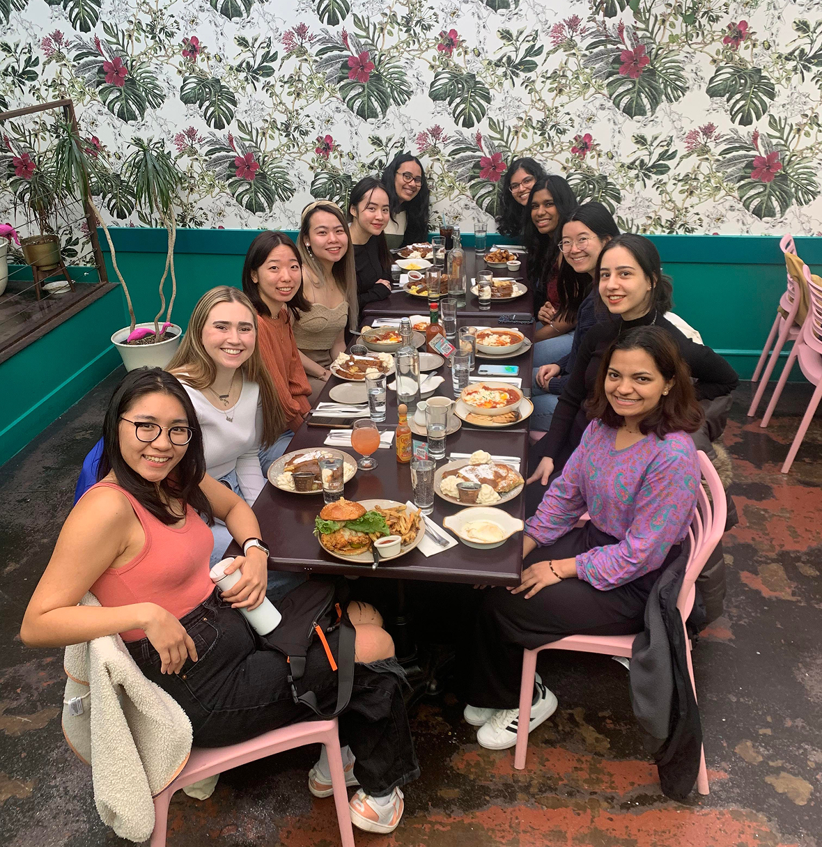 large group of women at dinner together smiling