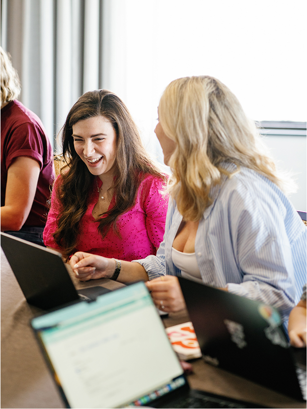 Jessica Furness and Jess Rush laughing at an RTC staff retreat