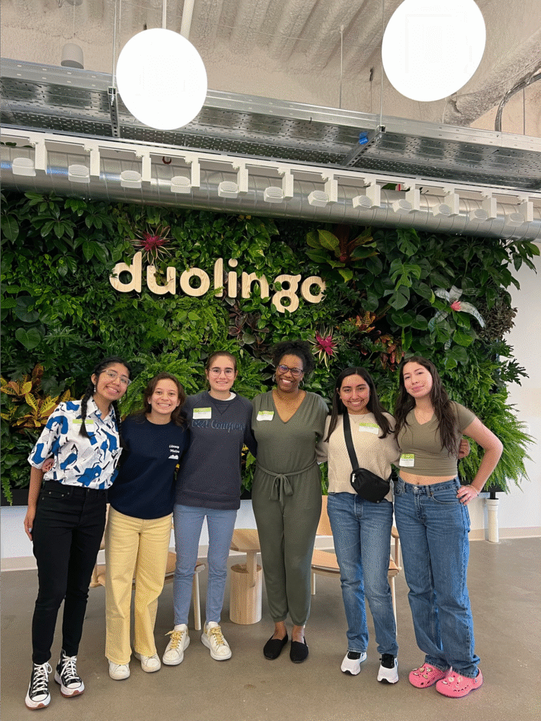six women standing in front of a duolingo sign