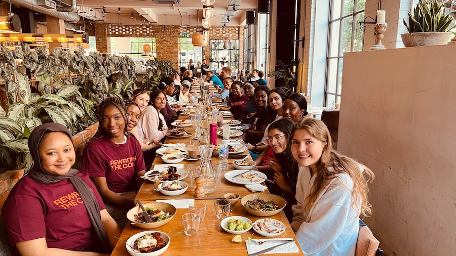 RTC members sitting at a restaurant table with food and smiling