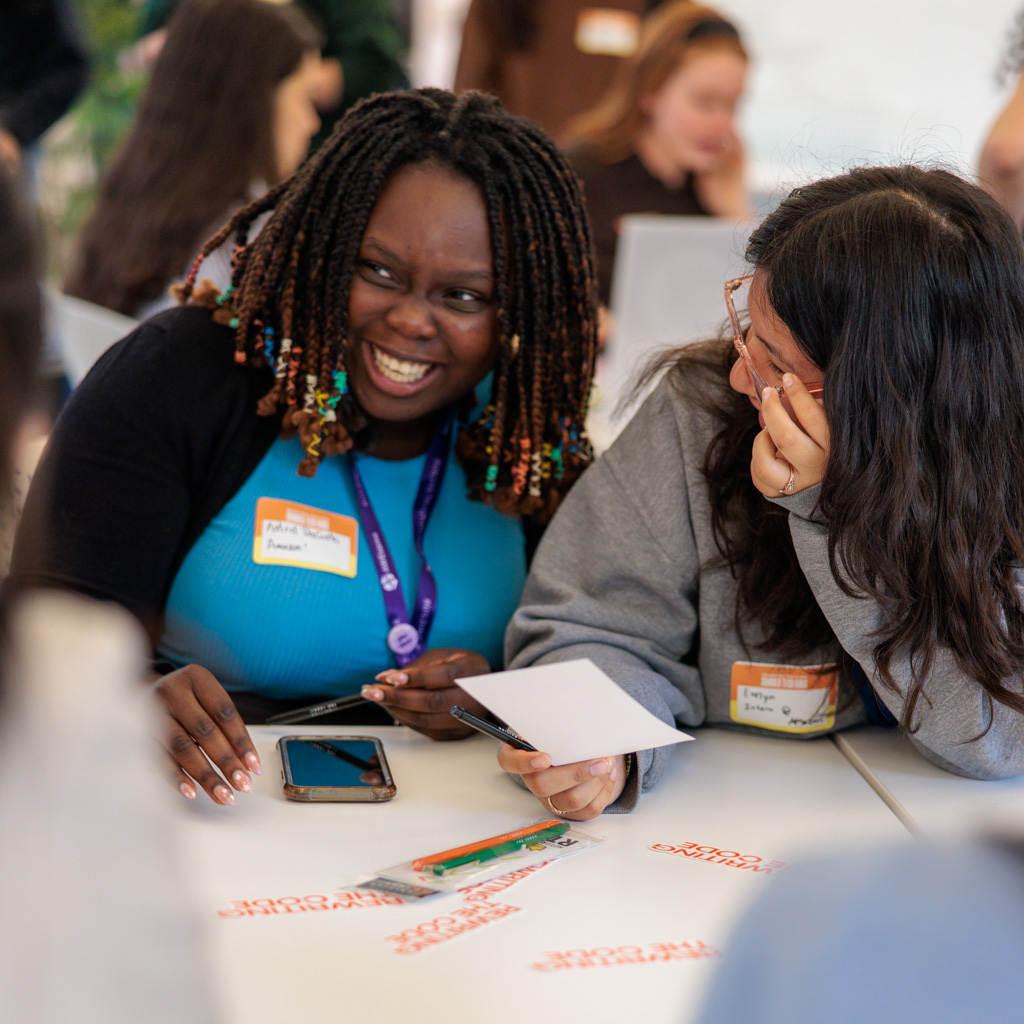 2 rtc members smiling and laughing