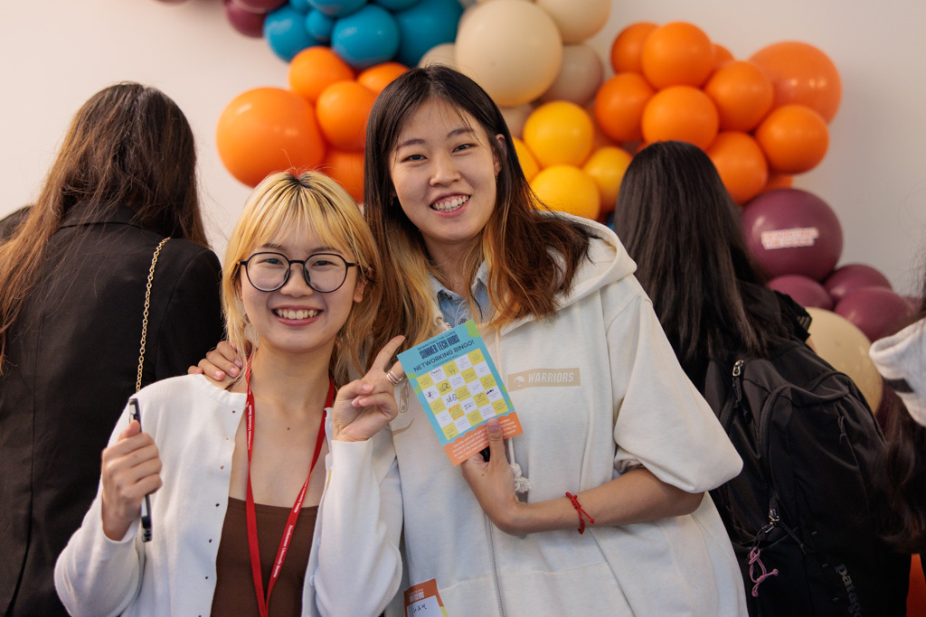 Two RTC members at a networking event smiling