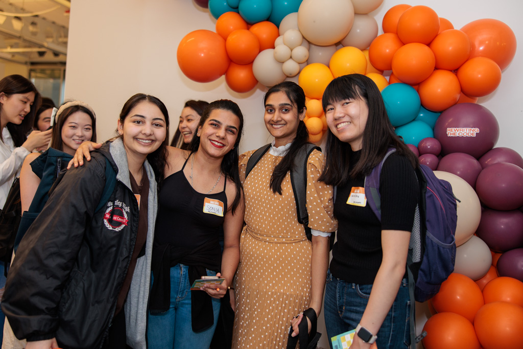4 rtc members in front of a colorful balloon arch
