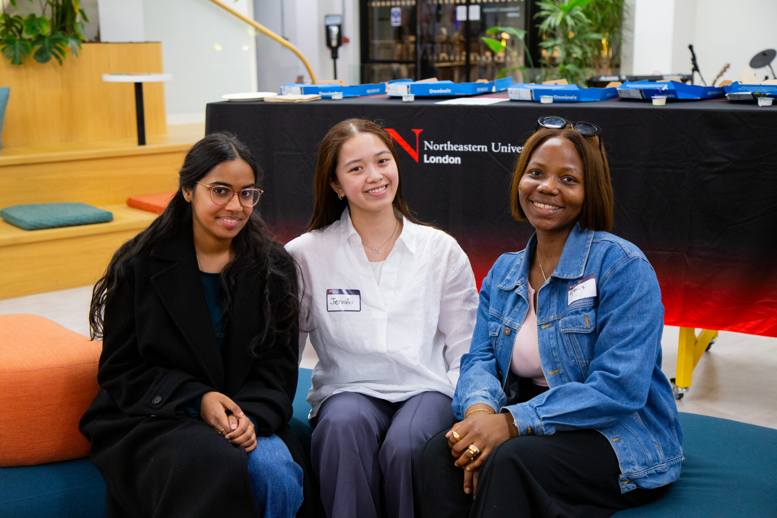 Three RTC members smiling at an event in London
