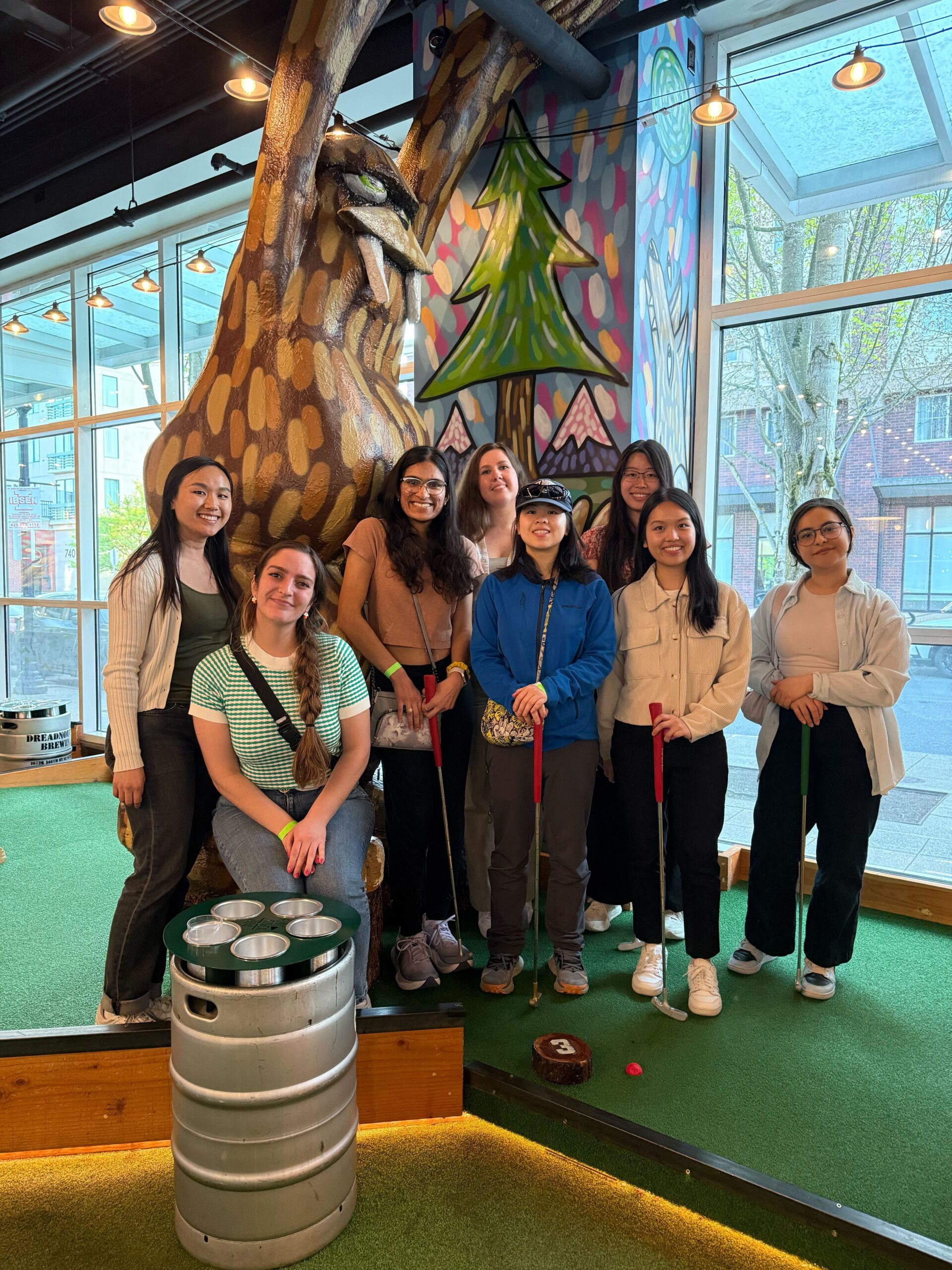 8 RTC members smiling and holding golf clubs