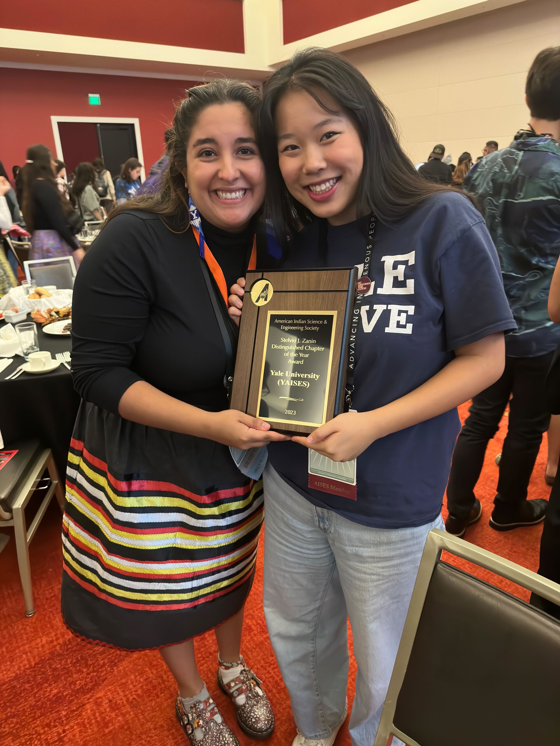 Two RTC members holding Yale University's AISES chapter of the year award
