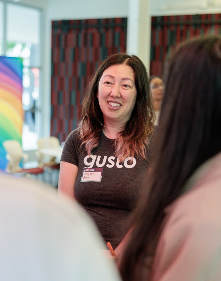Woman wearing a Gusto shirt networking at an event