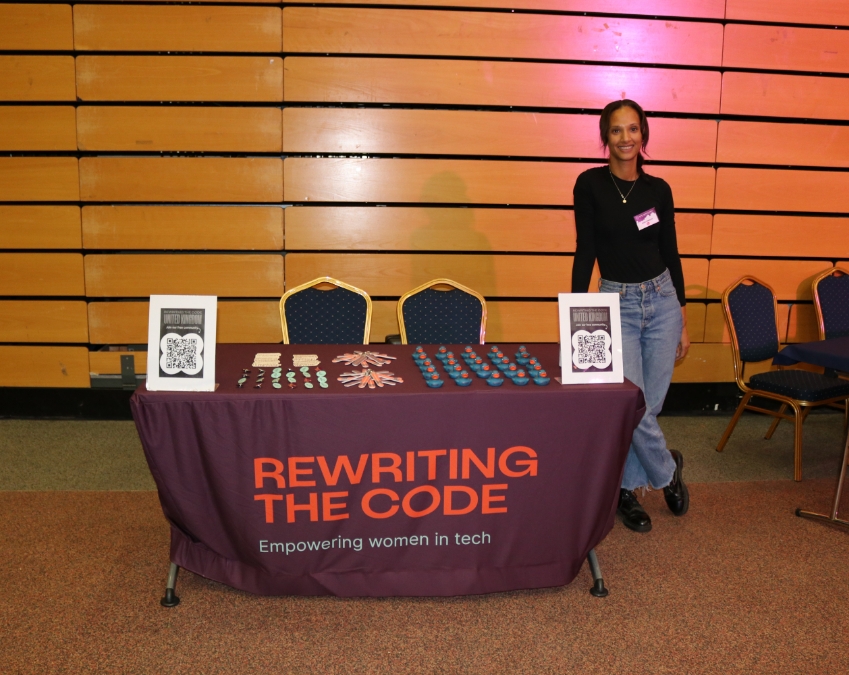 RTC team member next to a booth at a conference