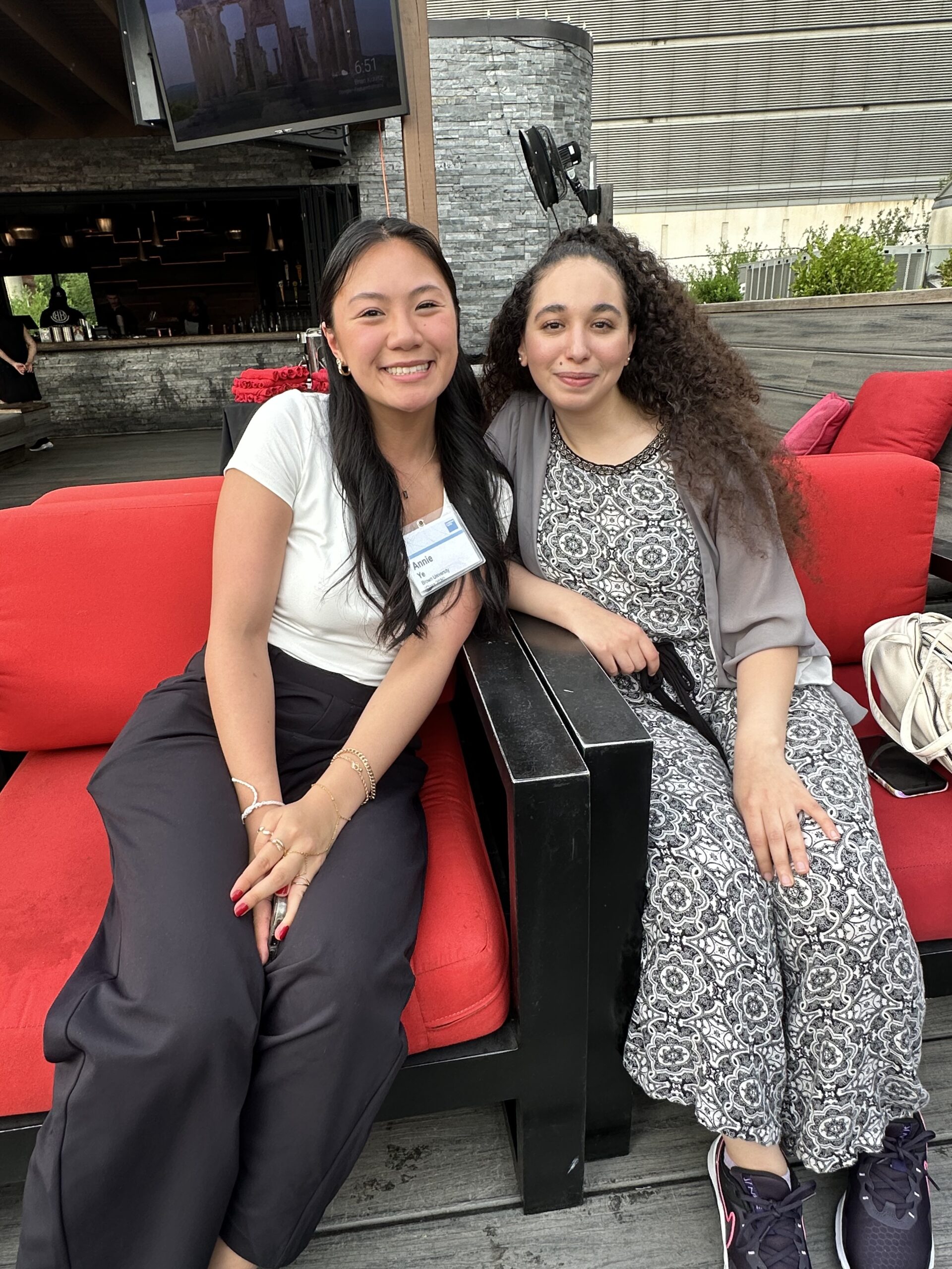 Two women smiling sitting together