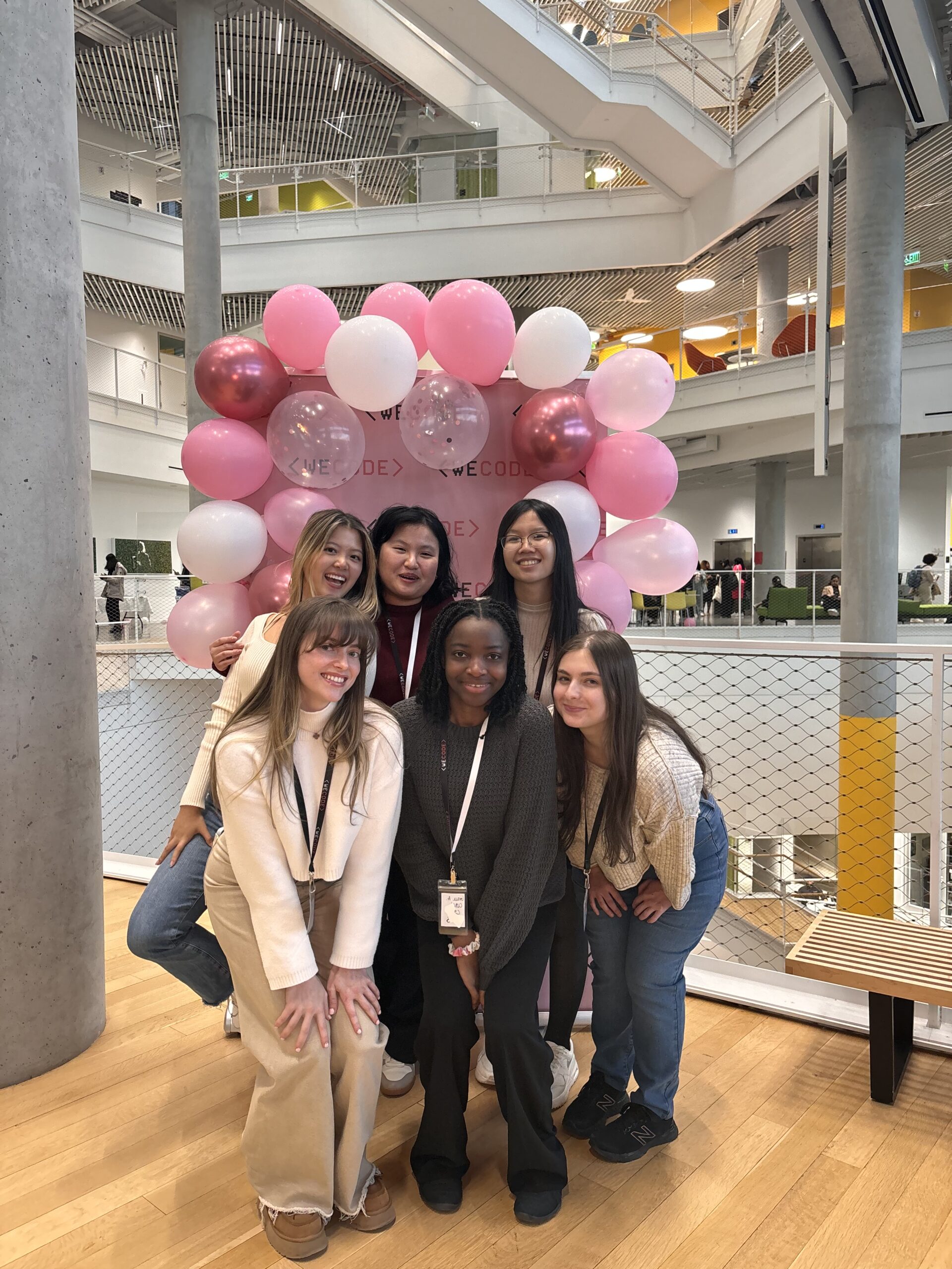 6 RTC members at WeCode in front of a balloon arch