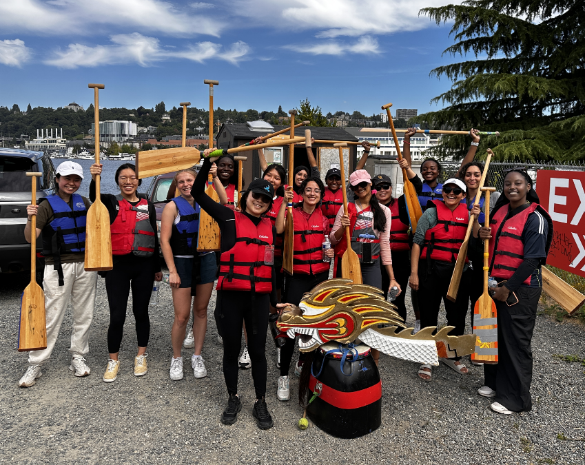RTC members wearing life vests and holding paddles